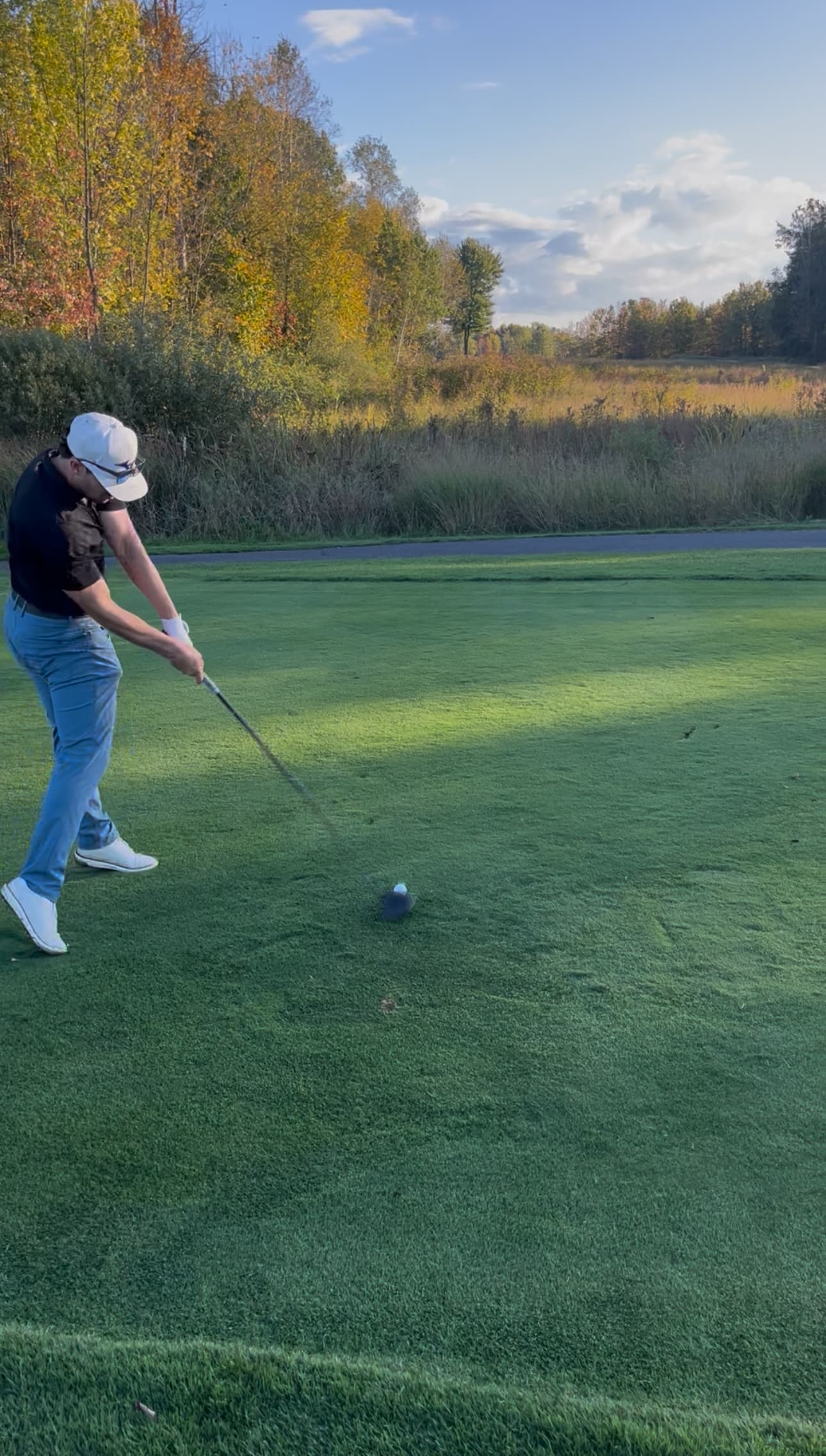 Seth finishing a swing on the course